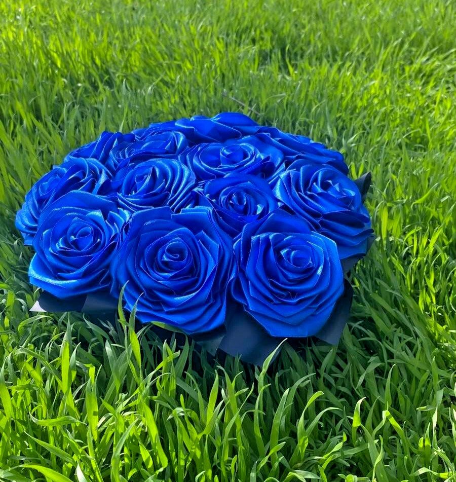 bouquet of blue roses from satin ribbons in a round black box