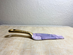 Contemporary cake server with purple marble blade and gold handle