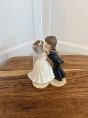 figurine is the «Kissing Couple» Western Wedding Cake Topper