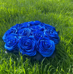 bouquet of blue roses from satin ribbons in a round black box