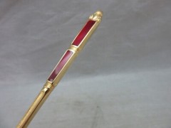 Gold plated cake server with red enamel handle