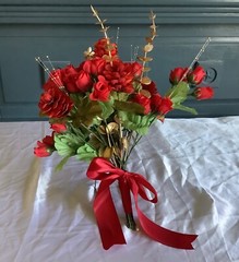 Red rosebuds, red blooms, gold eucalyptus and gold crystals bridal bouquet