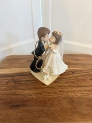 figurine is the «Kissing Couple» Western Wedding Cake Topper