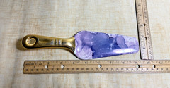 Contemporary cake server with purple marble blade and gold handle